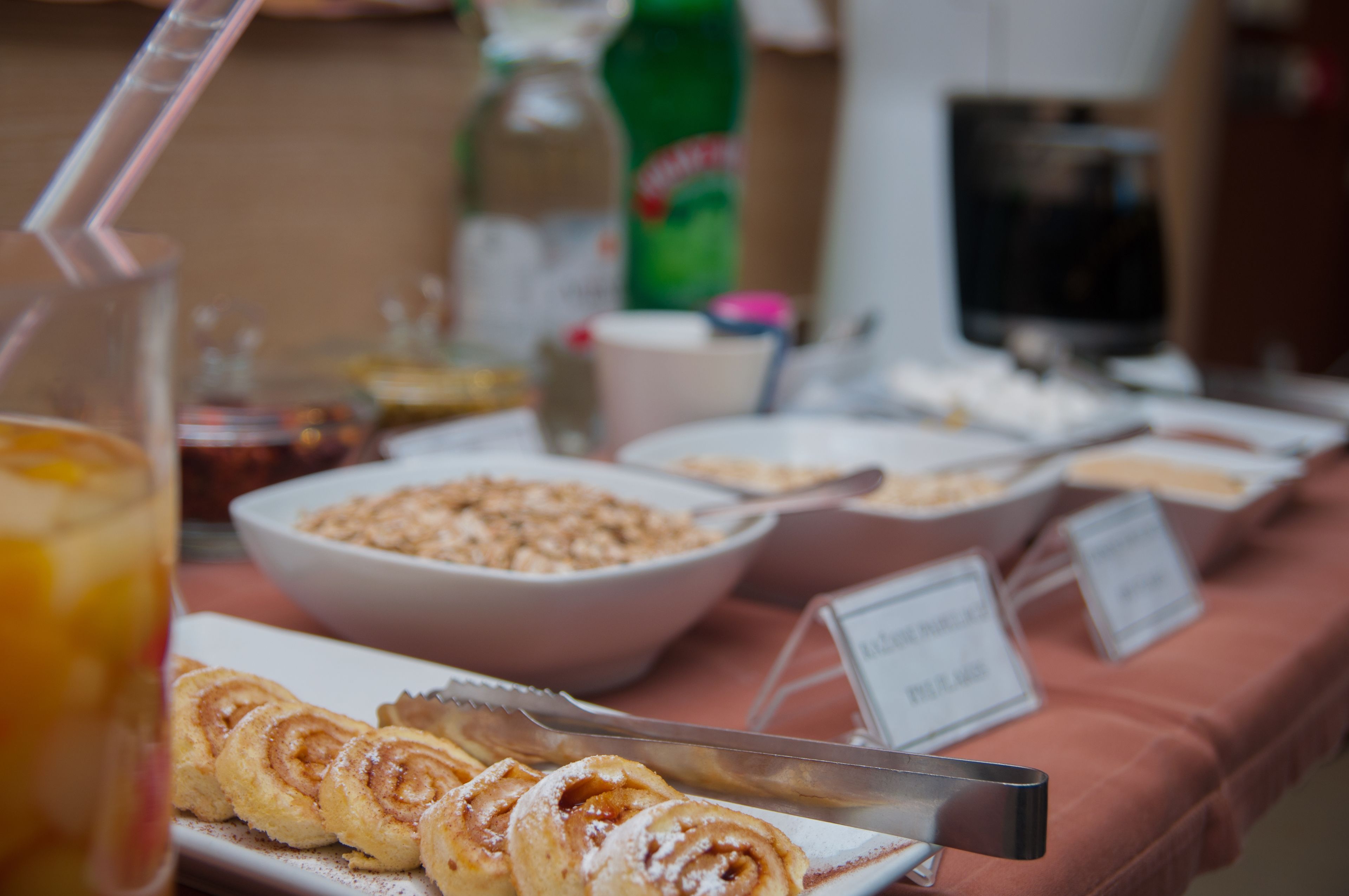 A buffet table with various food items and a beverage.