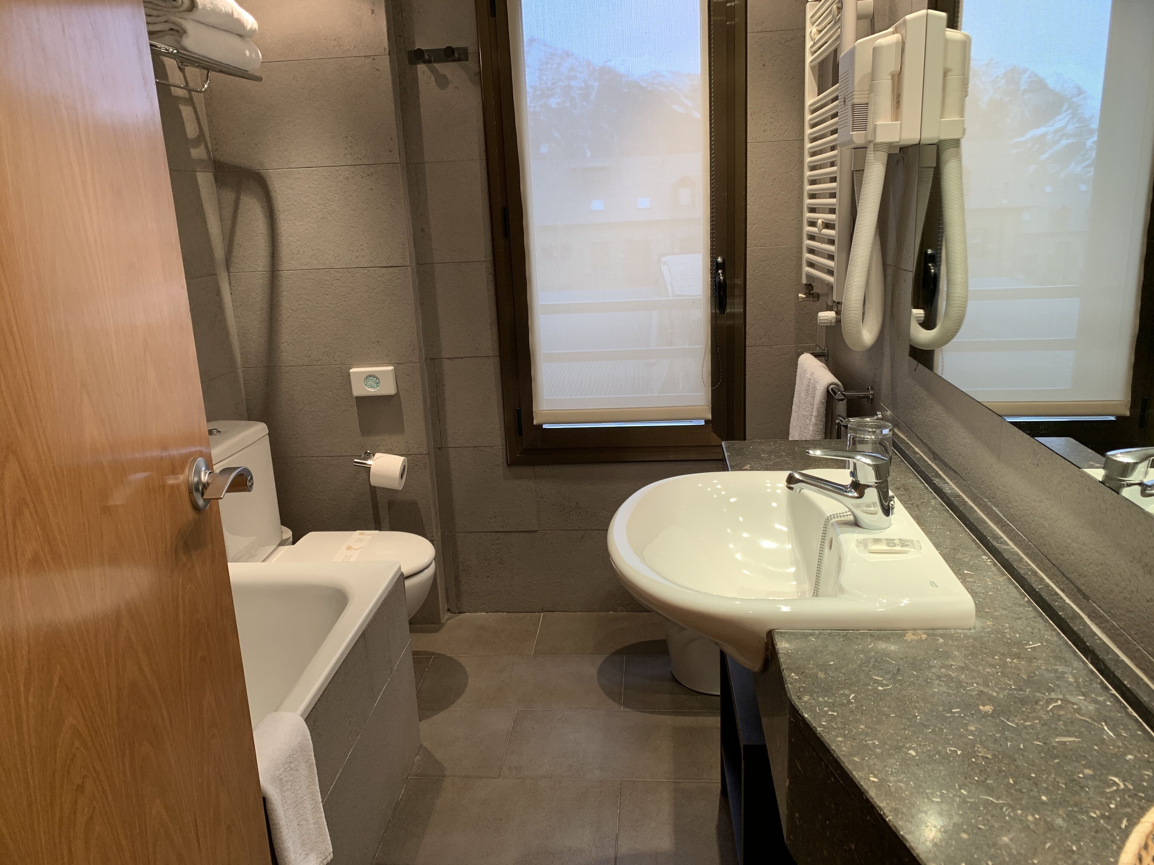 A bathroom with a bathtub, toilet, and sink.