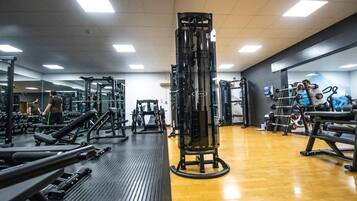 A gym with various exercise equipment, including weight machines and free weights.
