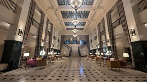 A grand lobby with a checkered floor, a central staircase, and chandeliers. - The Mayo Hotel (Tulsa)