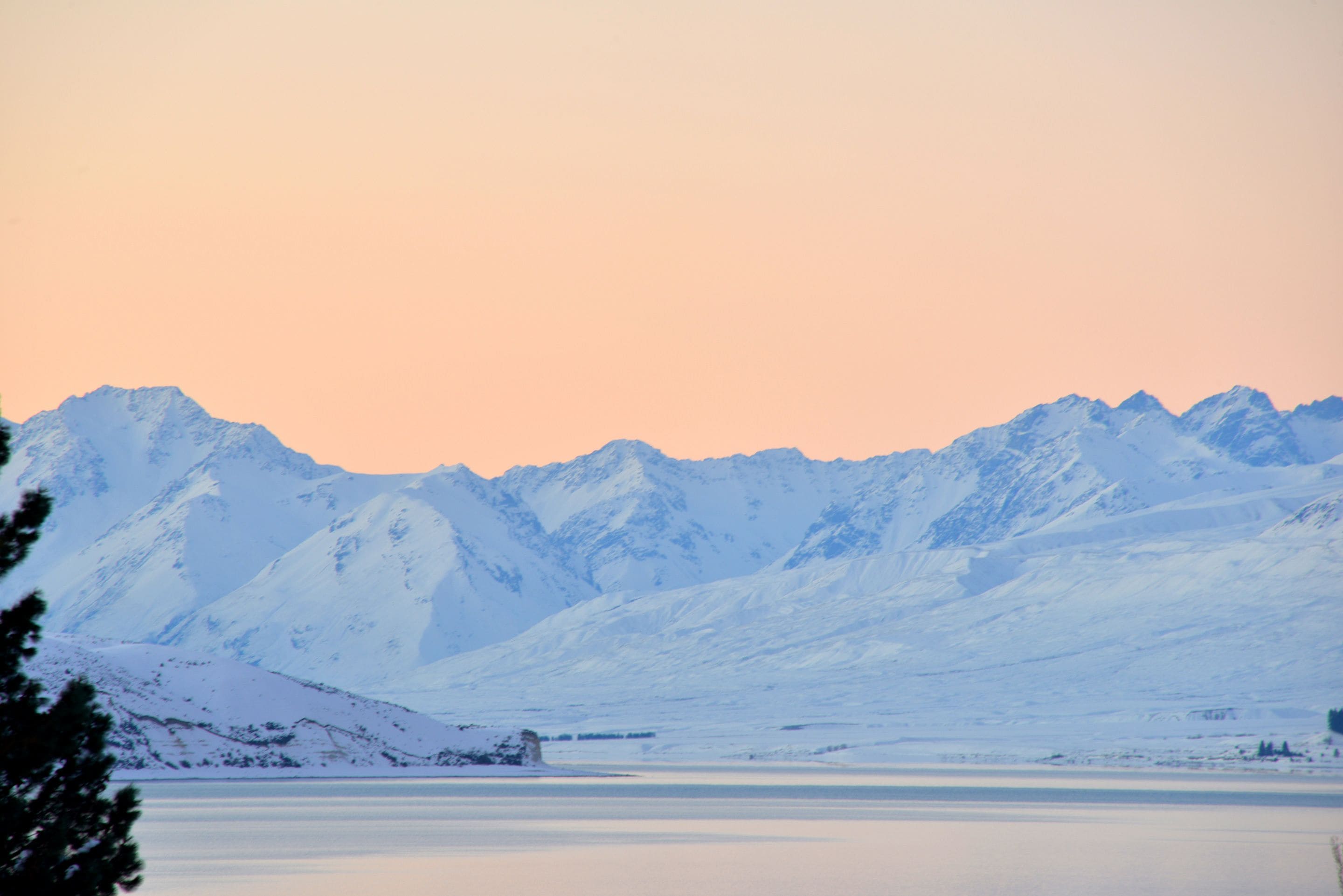 A snow-covered mountain range with a clear sky.