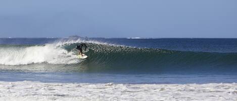 A surfer riding a wave in the ocean.