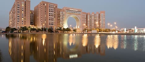 A large hotel with a prominent archway and multiple high-rise buildings.