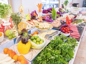 A buffet with various food items and utensils. - Arora Hotel (Kusadasi)