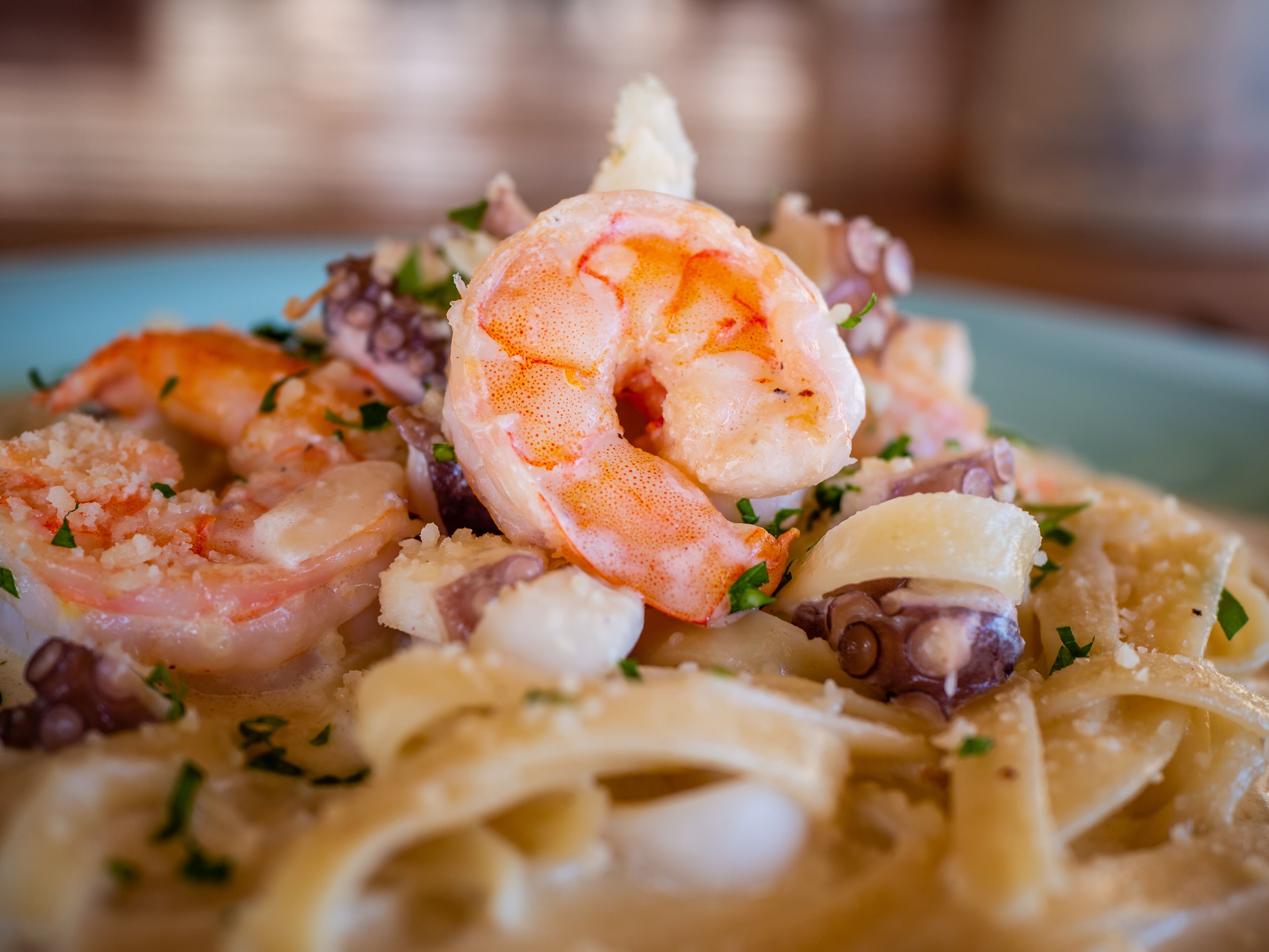 A plate of pasta with shrimp and octopus.