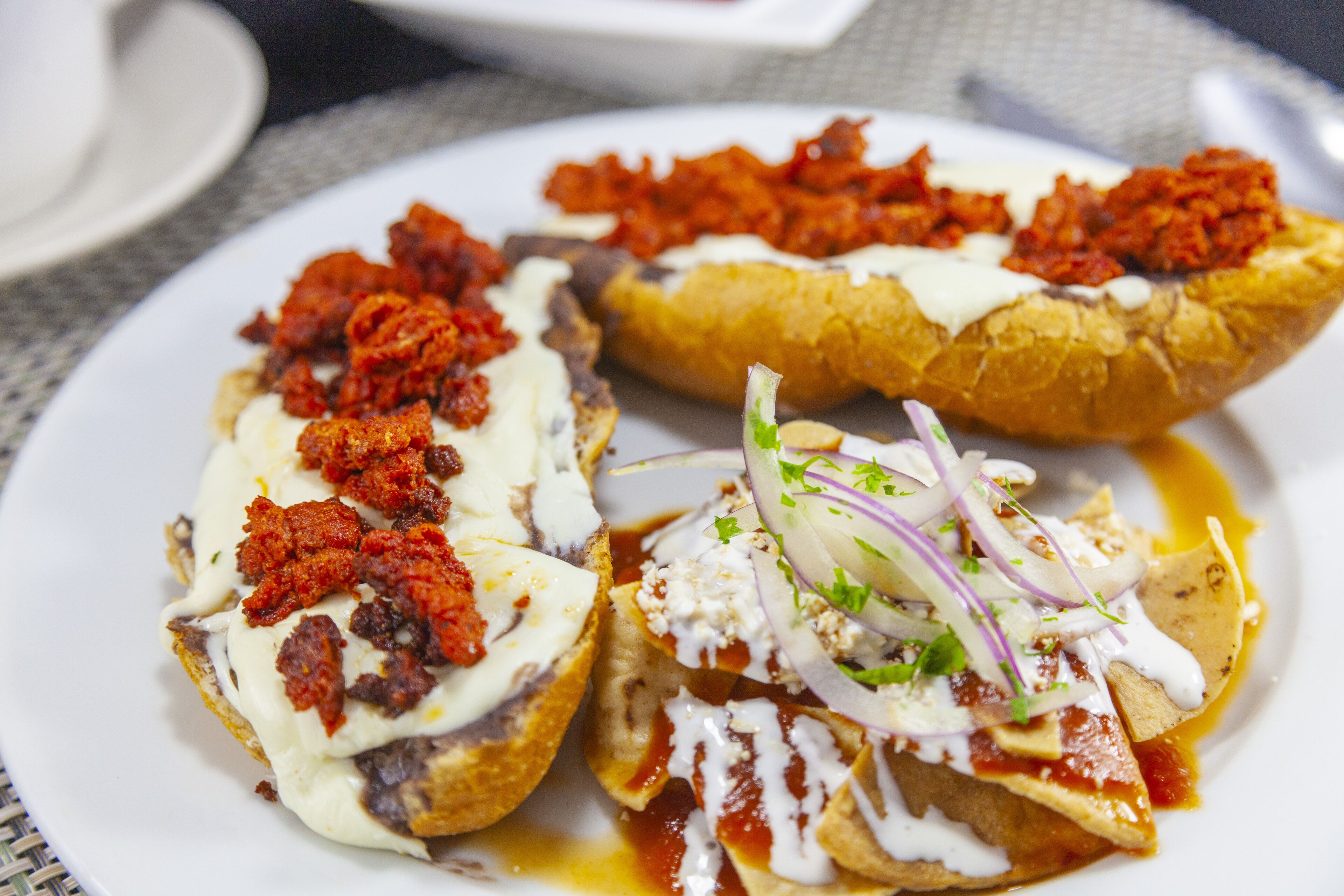 A plate with three different types of nachos.