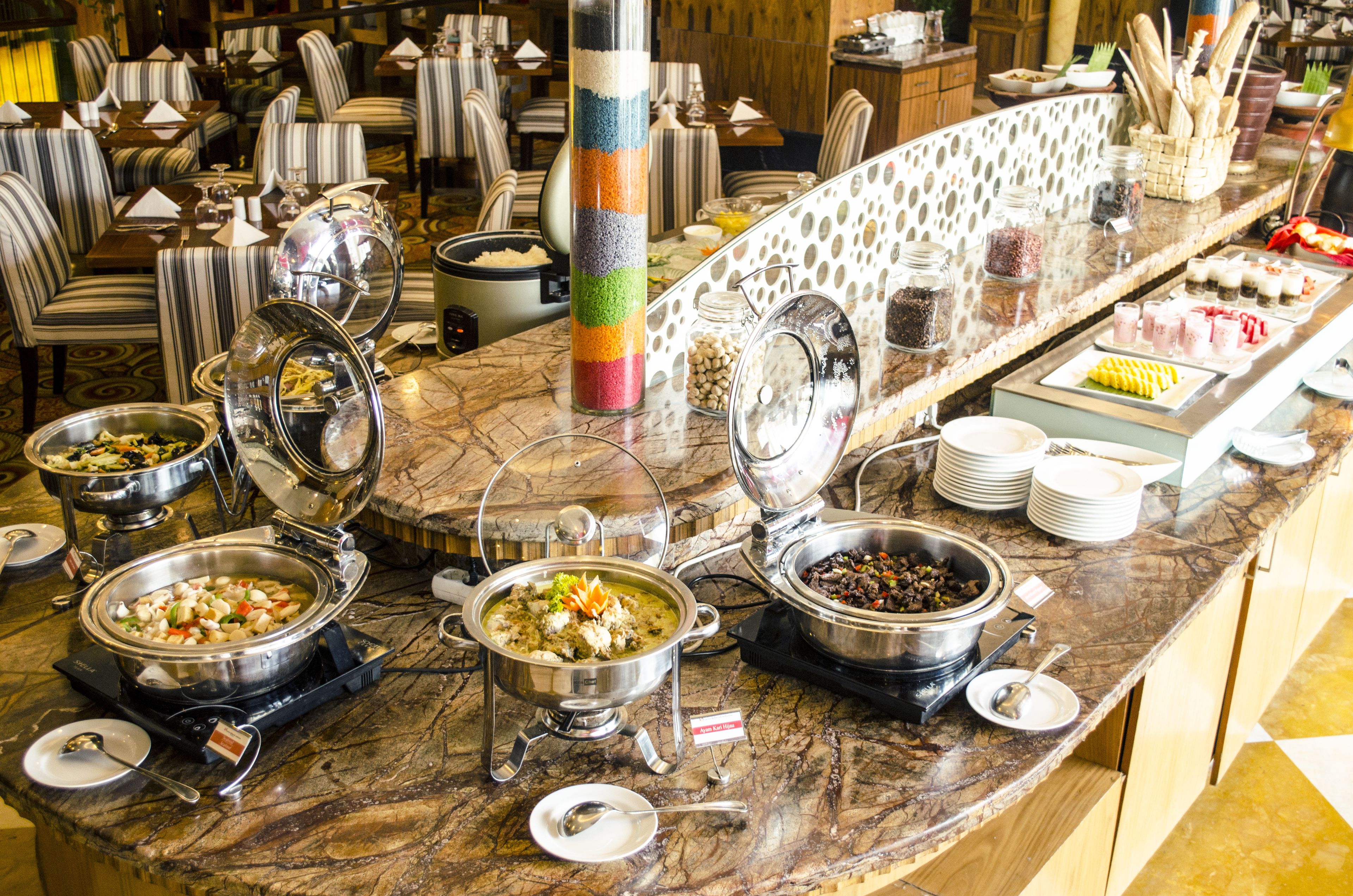 A buffet setup with various food stations and seating arrangements.