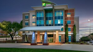A Holiday Inn Express hotel with a modern design, featuring large windows and a prominent entrance. - Holiday Inn Express & Suites North Dallas at Preston by IHG (Dallas)
