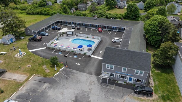 A motel with a swimming pool, parking lot, and a small gazebo. - Jonathan Edwards Motel (Dennis Port)