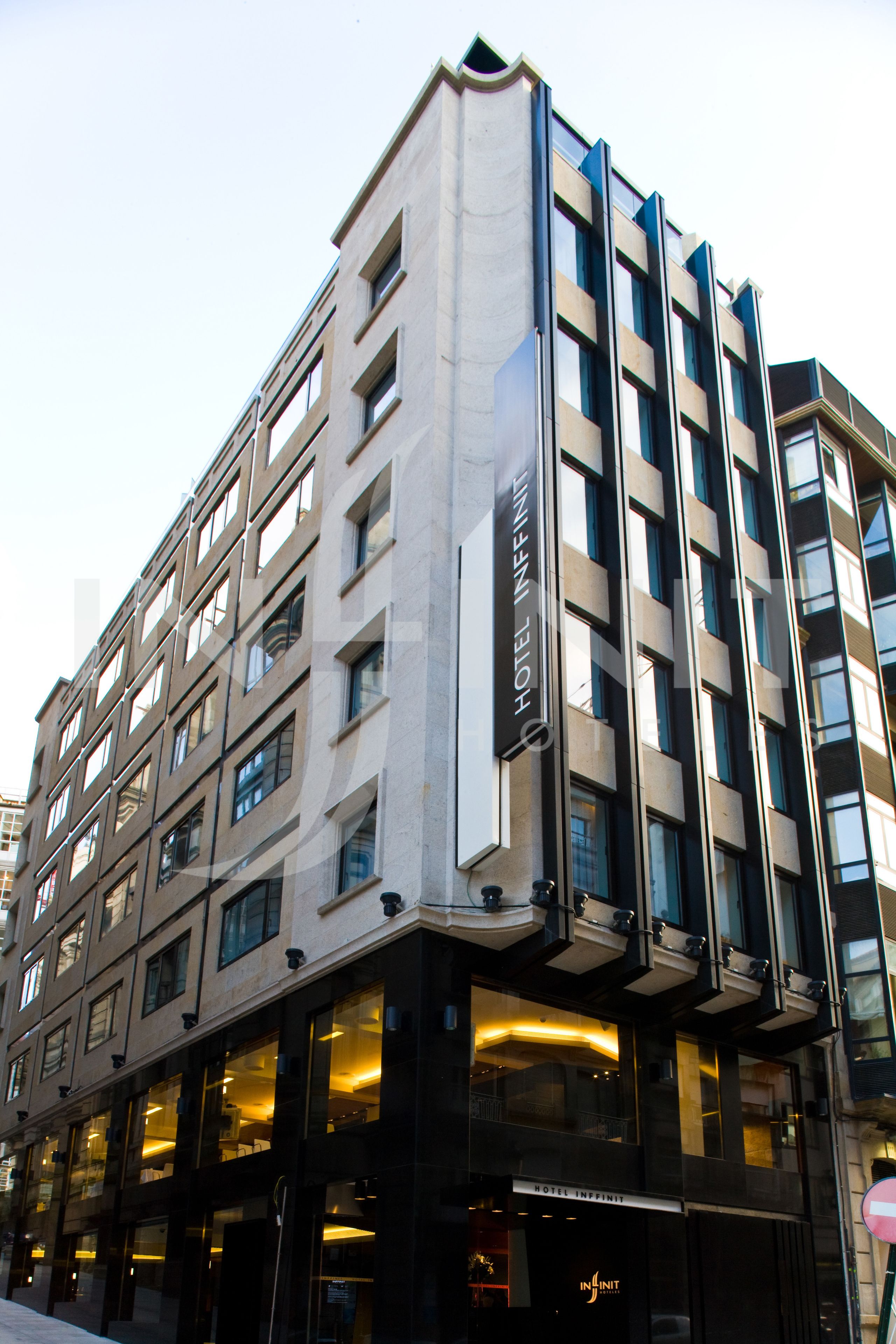 A multi-story hotel with a modern architectural design, featuring large windows and a prominent entrance.