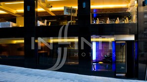 A modern hotel with a glass facade, a visible reception area, and a well-lit interior. - Hotel Inffinit (Vigo)