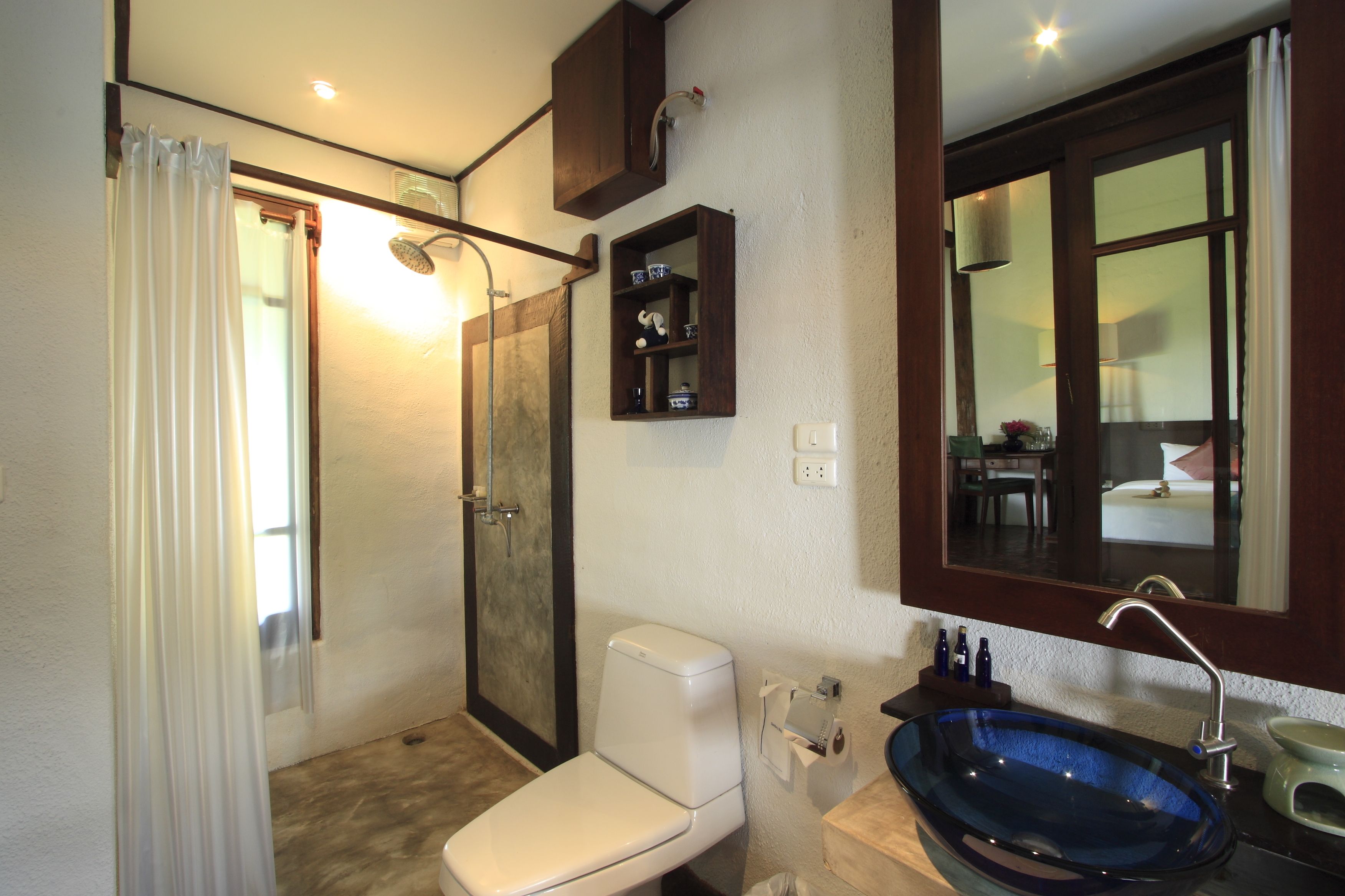 deluxe room | bathroom | rainfall showerhead, hair dryer, bathrobes, slippers