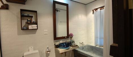 A bathroom with a toilet, sink, and bathtub.