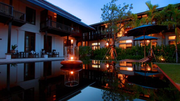 A hotel with a pool, outdoor seating, and a well-lit garden area. - Banthai Village (Chiang Mai)