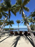 Private beach, white sand, beach towels, windsurfing