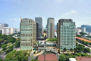 A modern hotel complex with multiple high-rise buildings, featuring a mix of glass and concrete facades, surrounded by lush greenery and a clear sky. - InterContinental Saigon, an IHG Hotel (Ho Chi Minh City)