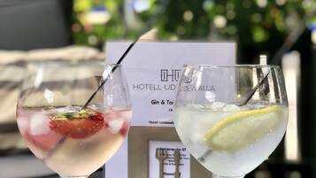 Two cocktails on a table with a menu in the background.