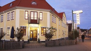A traditional building with a sign indicating it is a hotel.