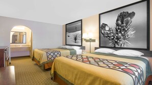 A hotel room with two beds, a desk, and a mirror. - Super 8 by Wyndham Idabel (Idabel)