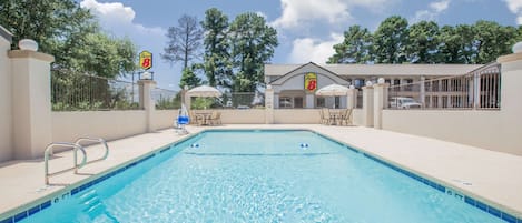 A swimming pool with a 6 ft depth marker, a no diving sign, and a 3 ft depth marker.