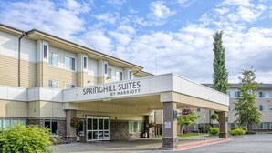 A hotel entrance with a sign reading "Springhill Suites by Marriott" and a covered walkway leading to the entrance. - SpringHill Suites Anchorage University Lake (Anchorage)