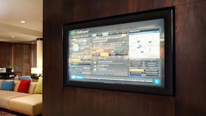 A GoBoard® screen displaying weather, news, and maps in a hotel lobby.