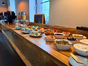 A buffet table with various food items and a coffee station. - Hotel George Vienna (Vienna)