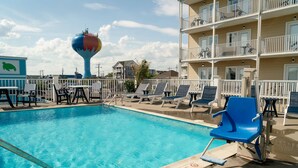 A swimming pool with lounge chairs and a water tower in the background. - Gateway Hotel & Suites Ocean City, an Ascend Collection Hotel (Ocean City)