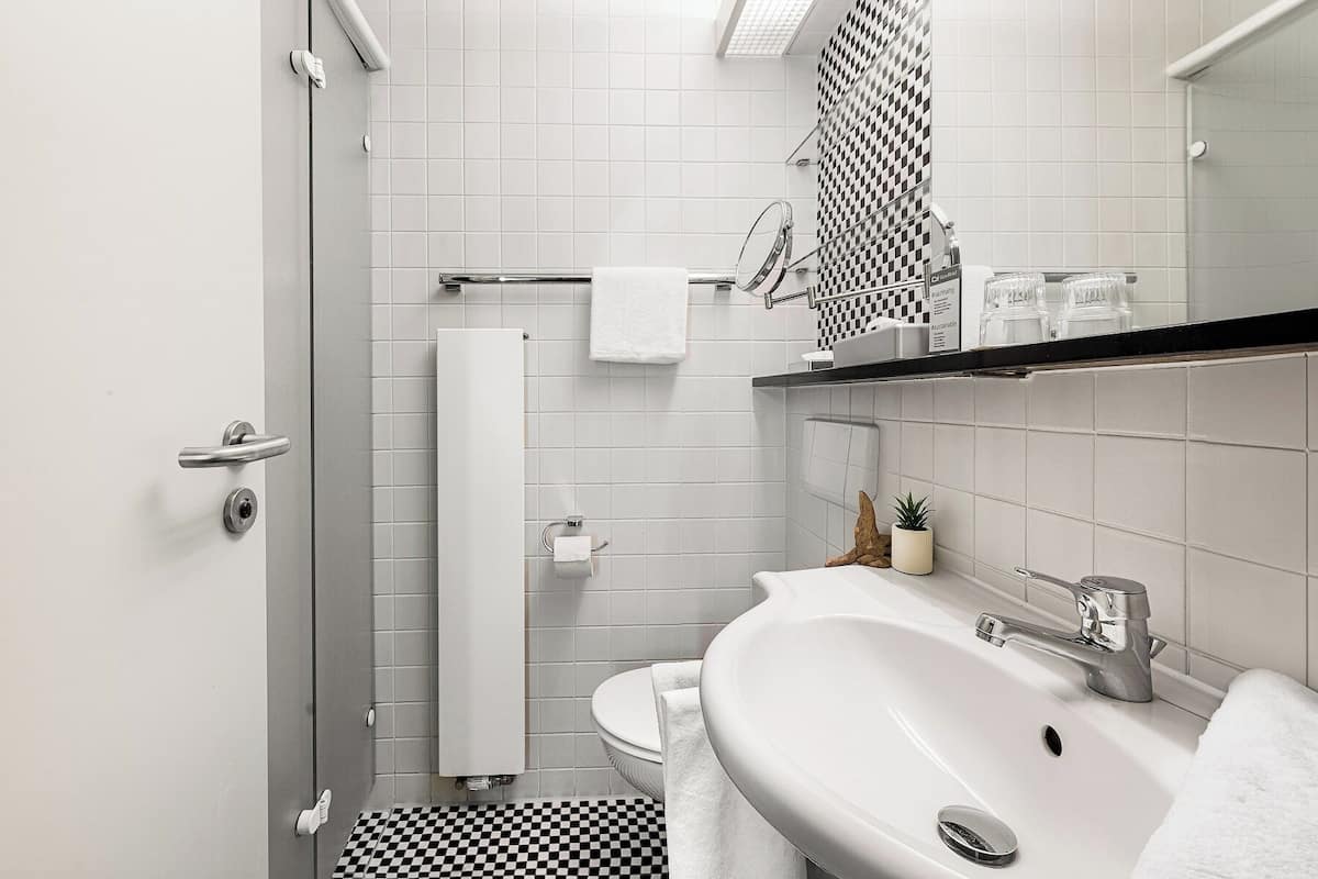 single room | bathroom | shower, hair dryer, towels, soap