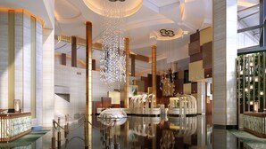 A modern lobby with a reflective floor, a central seating area, and a distinctive ceiling design. - Grand Hyatt Macau (Cotai)