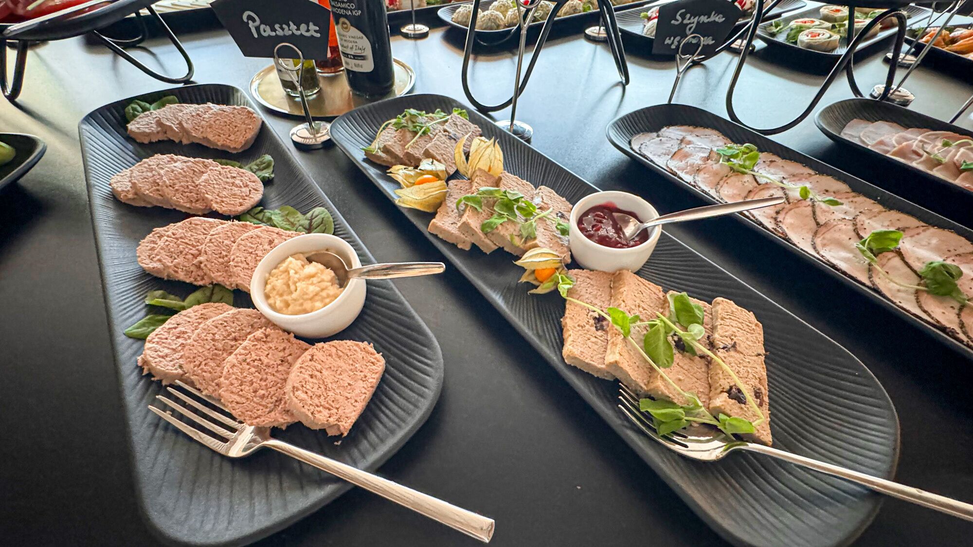 A buffet with various dishes including pâté, pâté with vegetables, and pâté with berries.