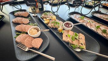A buffet with various dishes including pâté, pâté with vegetables, and pâté with berries.