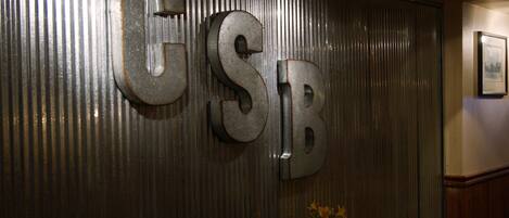 A wall with large metallic letters spelling "GSB".