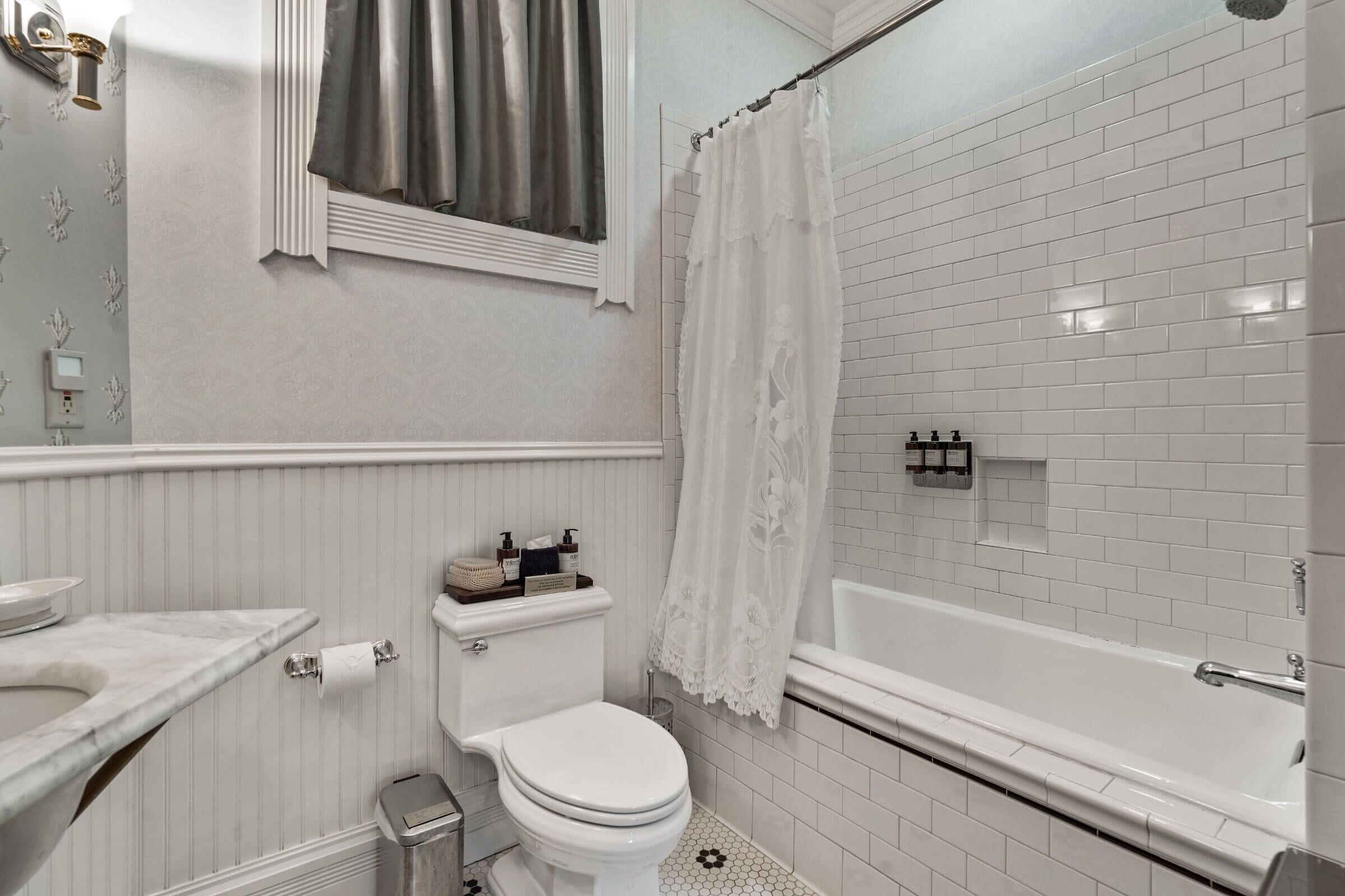 Un baño con inodoro, lavamanos y bañera.