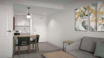 A modern living room with a grey sofa, a wooden coffee table, and a dining area with a table and chairs.