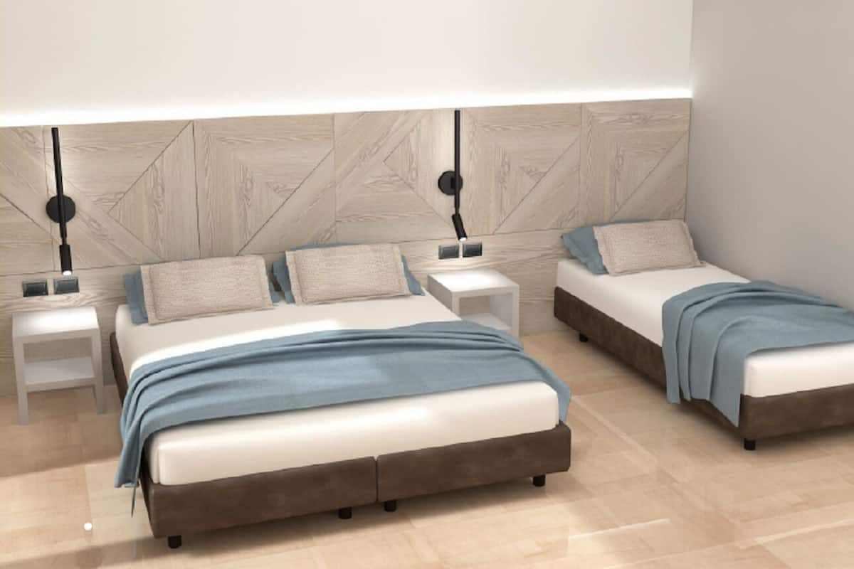 A modern bedroom with two beds, a nightstand with a lamp, and a wooden wall panel.