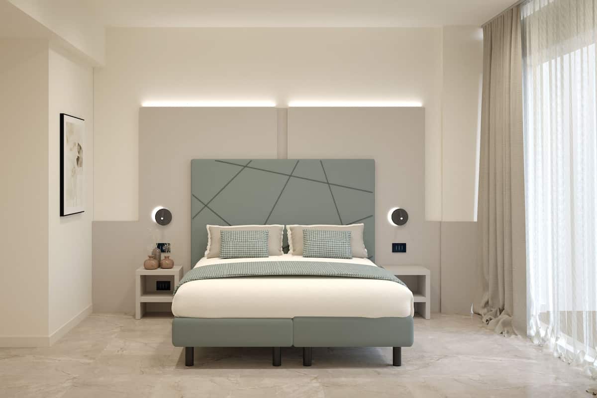 A modern bedroom with a large bed, bedside tables, and a headboard with geometric patterns.