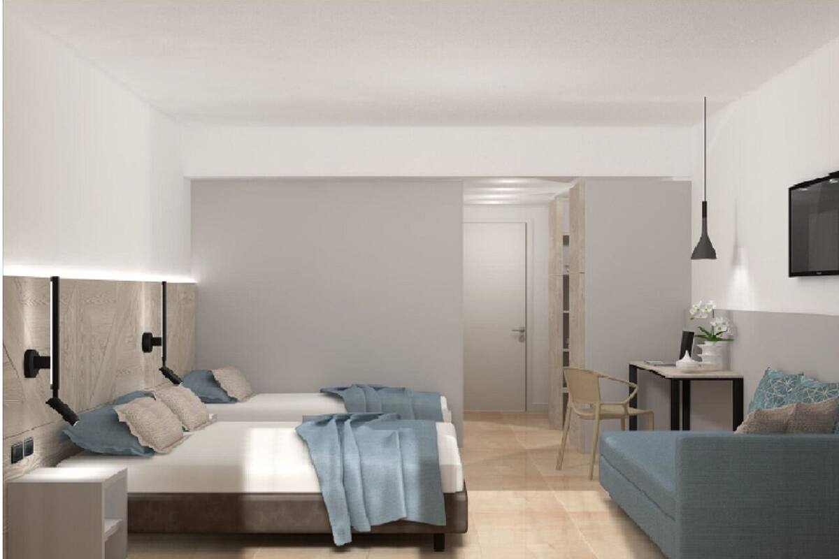 A modern bedroom with a bed, bedside tables, a desk, and a chair.