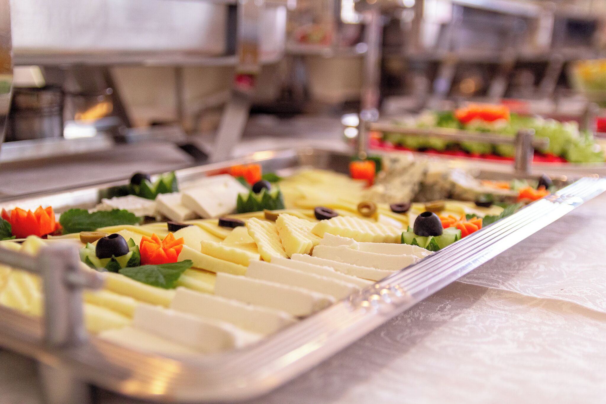 A buffet with various food items and garnishes.