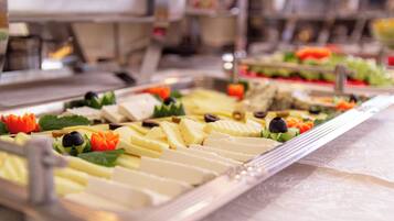 A buffet with various food items and garnishes.