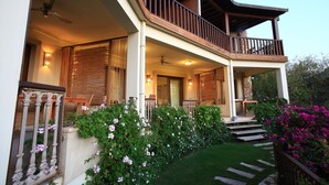 A two-story house with a balcony, a staircase leading to the upper floor, and a well-maintained garden with flowering plants. - Sandima 37 Suites Hotel (Bodrum)