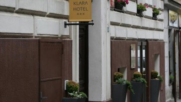 A hotel sign with the name 'KLARA HOTEL' and a large 'K' logo. - Hotel Klára (Prague)