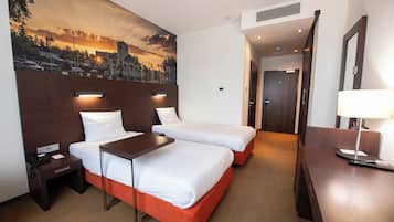 Ropa de cama hipoalergénica y caja de seguridad en la habitación