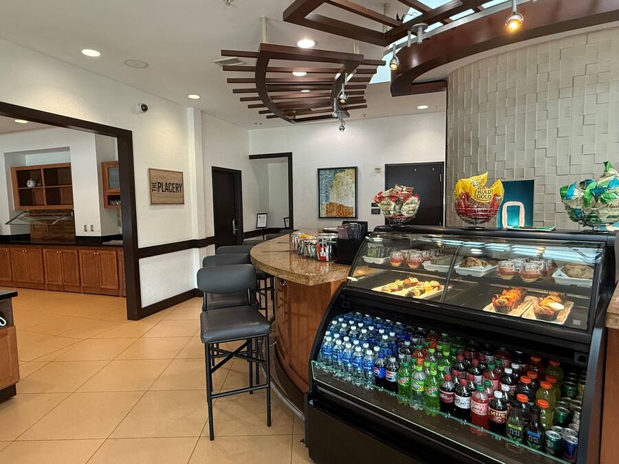 A bakery counter with pastries and a beverage display.