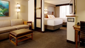 A hotel room with a sofa, a bed, a desk, and a TV. - Hyatt Place Fort Myers/at The Forum (Fort Myers)