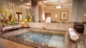 A spa area with a hot tub, a towel rack, and a decorative plant arrangement. - The SKYLOFTS at MGM Grand (Las Vegas)