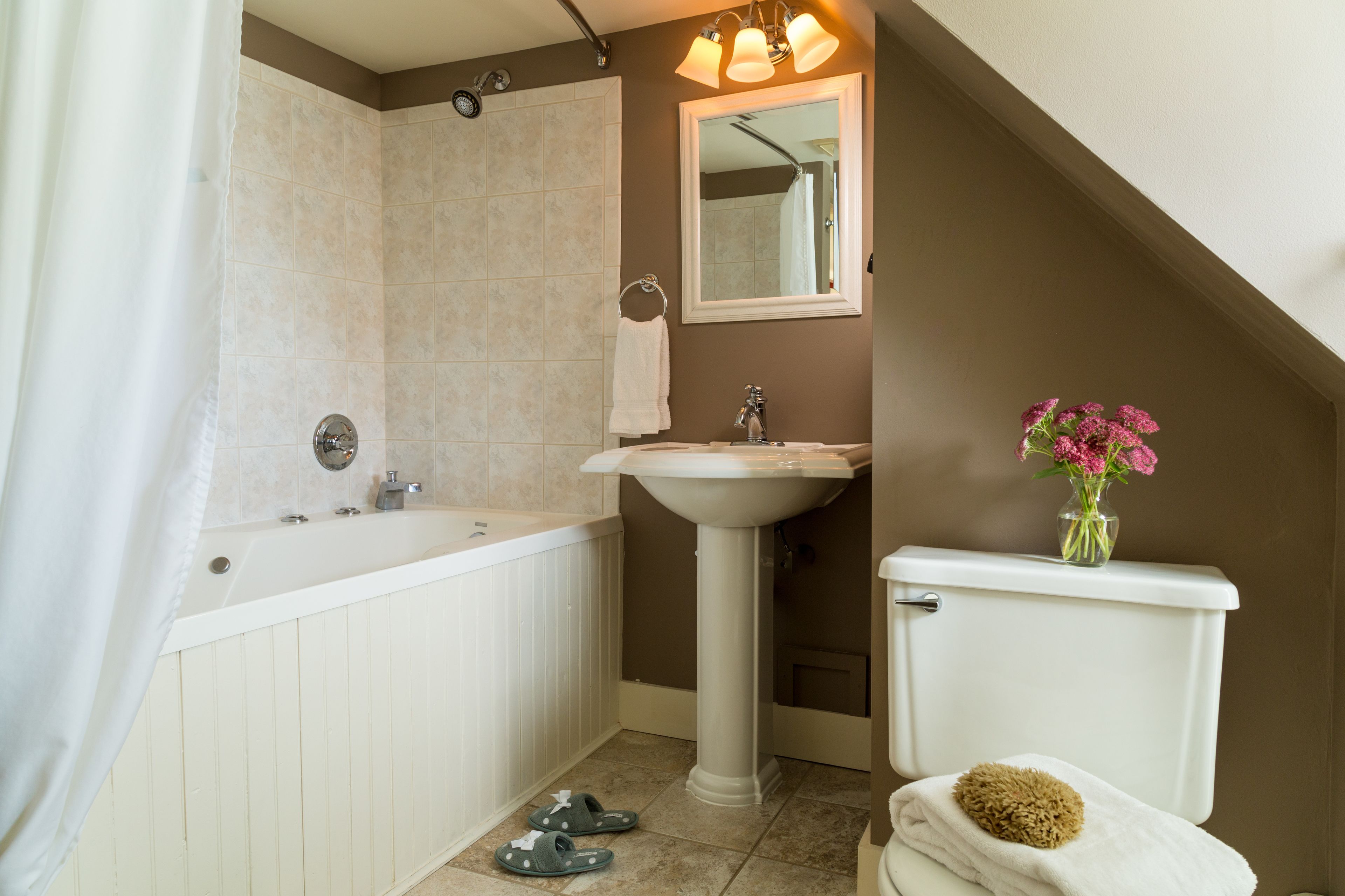 A bathroom with a bathtub, sink, and toilet.