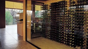 A wine cellar with a large number of wine bottles organized in racks. - Honeyguide Tented Safari Camps - Mantobeni (Bushbuckridge)