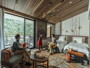A modern hotel room with a large balcony, two beds, a seating area, and a dining table. - Karuizawa Prince Hotel West (Karuizawa)