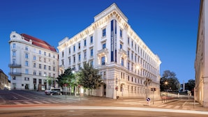A grand, historic building with classical architecture, featuring multiple stories, large windows, and a prominent entrance. - Grand Palace Brno - Small Luxury Hotels of the World (Brno)